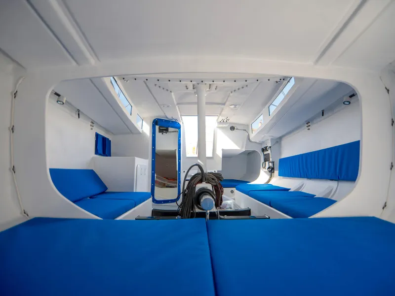 Slide: The Image of Interior of Black Pepper Code 0.1 sailboat, 2025 model, featuring blue seating and modern design. - 27