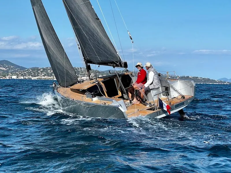 Slide: The Image of Sailing yacht Black Pepper Code 0.1, 2025 model, navigating ocean waters with crew onboard. - 8