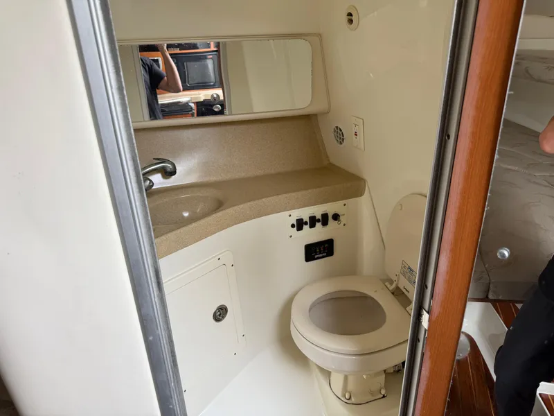 Slide: The Image of 2005 Hydra-Sports Vector 3300 VX boat bathroom with sink, toilet, and mirror. - 10