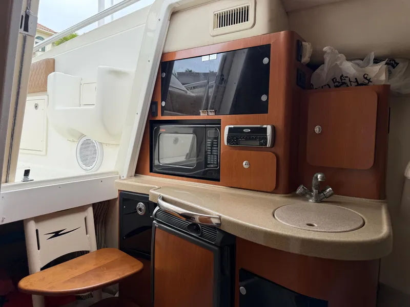 Slide: The Image of 2005 Hydra-Sports Vector 3300 VX cabin with kitchenette, microwave, and sink. - 11