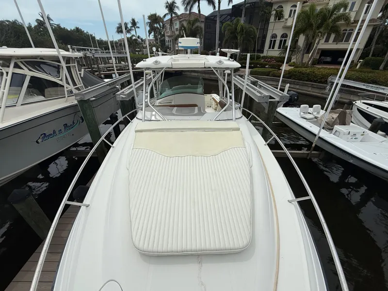 Slide: The Image of 2005 Hydra-Sports Vector 3300 VX boat docked at marina, featuring spacious deck and sleek design. - 14
