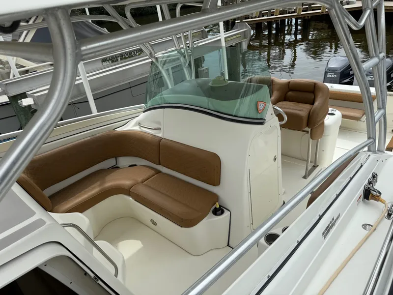 Slide: The Image of 2005 Hydra-Sports Vector 3300 VX boat interior with brown seating and helm. - 17