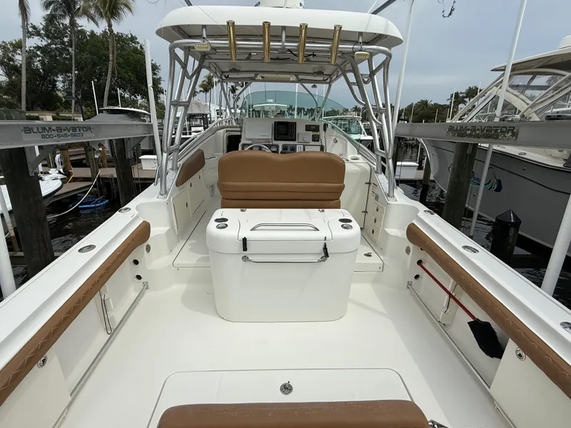 Slide: The Image of 2005 Hydra-Sports Vector 3300 VX boat interior with seating and helm, docked at marina. - 21