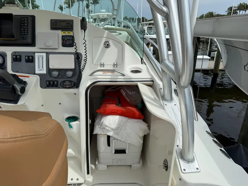 Slide: The Image of 2005 Hydra-Sports Vector 3300 VX boat interior with navigation equipment and storage compartment. - 26