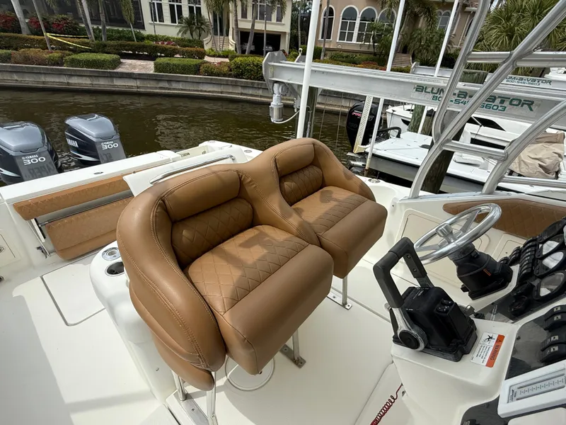 Slide: The Image of 2005 Hydra-Sports Vector 3300 VX boat with tan leather seats and dual outboard engines. - 27