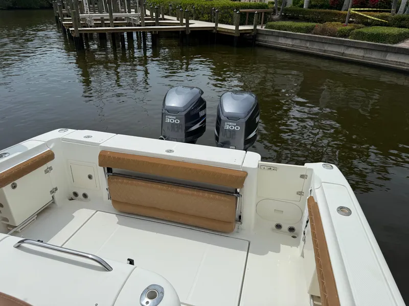 Slide: The Image of 2005 Hydra-Sports Vector 3300 VX boat with twin 300 horsepower engines docked by the water. - 35