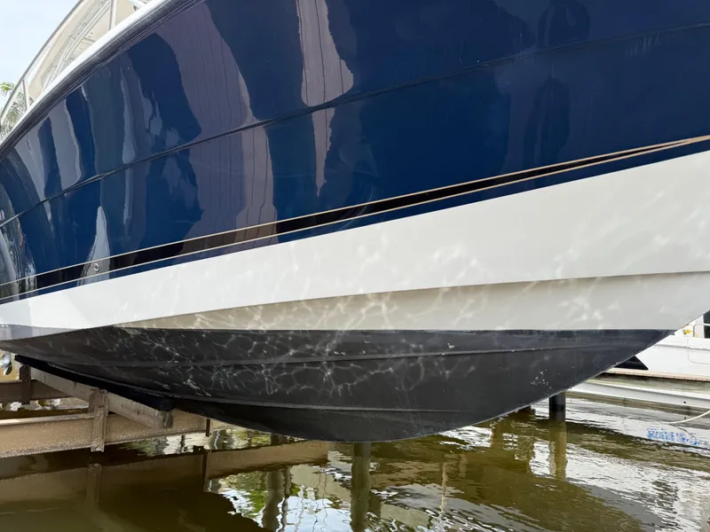 Slide: The Image of 2005 Hydra-Sports Vector 3300 VX boat hull in dry dock, reflecting water patterns. - 38