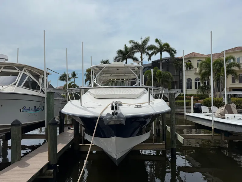 Slide: The Image of 2005 Hydra-Sports Vector 3300 VX boat docked at marina with palm trees in background. - 39