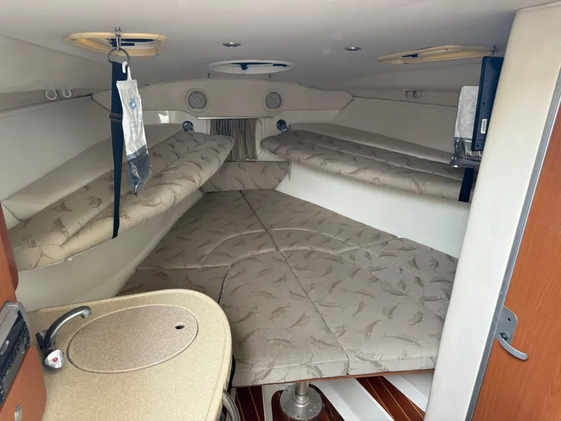 Slide: The Image of 2005 Hydra-Sports Vector 3300 VX cabin interior with beige upholstery and compact kitchenette. - 9