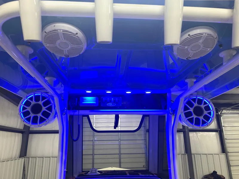 Slide: The Image of 2020 Sea Hunt Ultra 275 SE boat with blue LED lights and speakers. - 10