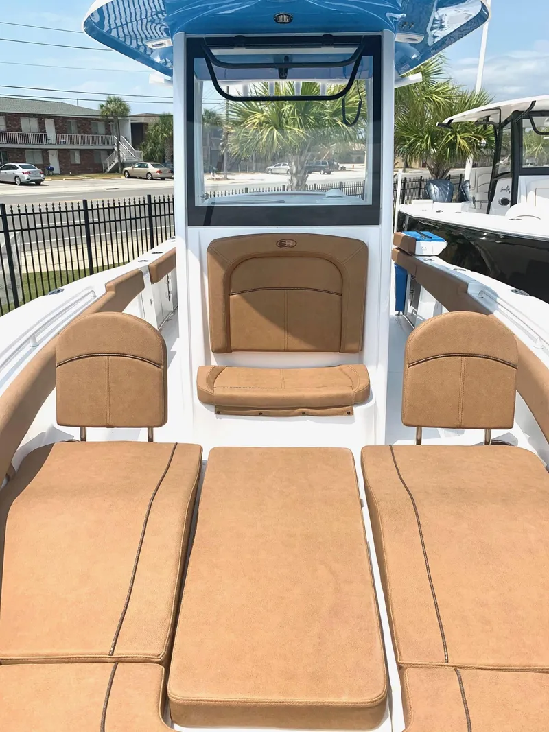 Slide: The Image of 2020 Sea Hunt Ultra 275 SE boat with tan seating and blue accents. - 7