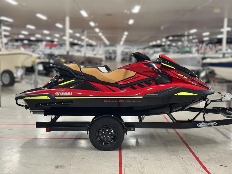 Slide: The Image of 2022 Yamaha WaveRunner FX Cruiser SVHO in showroom, red and black design on trailer. - 2