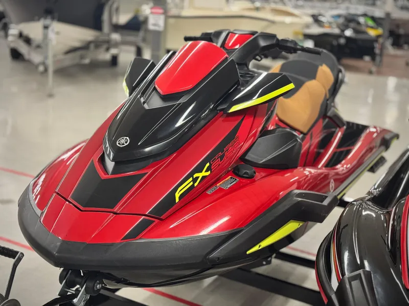 Slide: The Image of 2022 Yamaha WaveRunner FX Cruiser SVHO in vibrant red and black, displayed indoors. - 3
