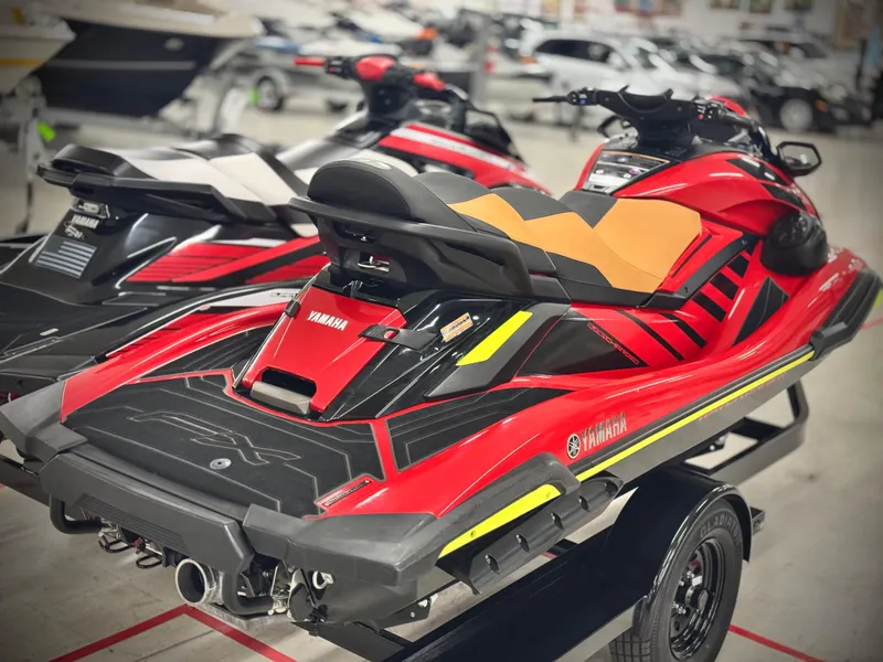 Slide: The Image of 2022 Yamaha WaveRunner FX Cruiser SVHO in showroom, vibrant red and black design. - 4