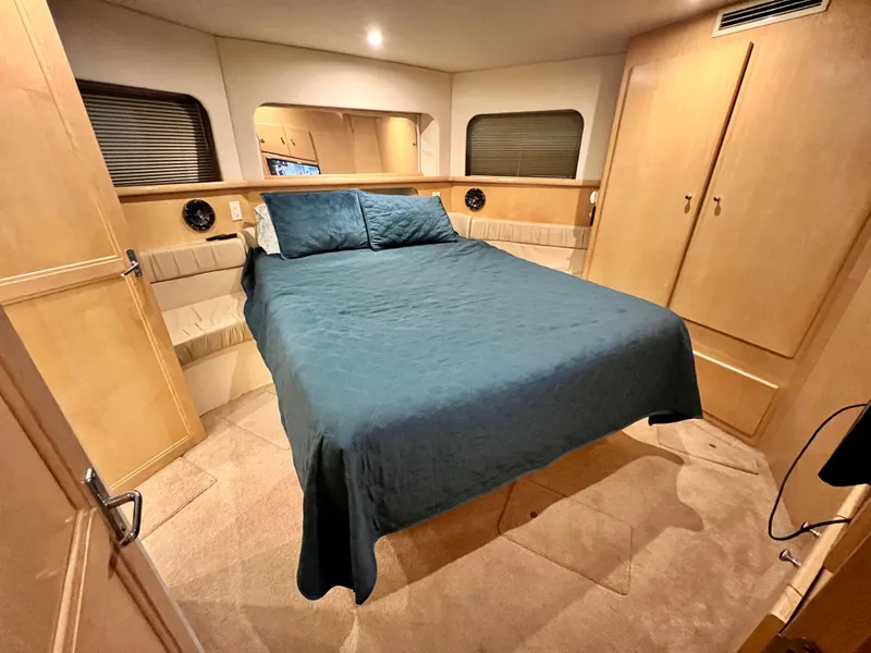 Slide: The Image of Luxurious bedroom in 1998 Carver 405 Aft Cabin yacht with blue bedding. - 14