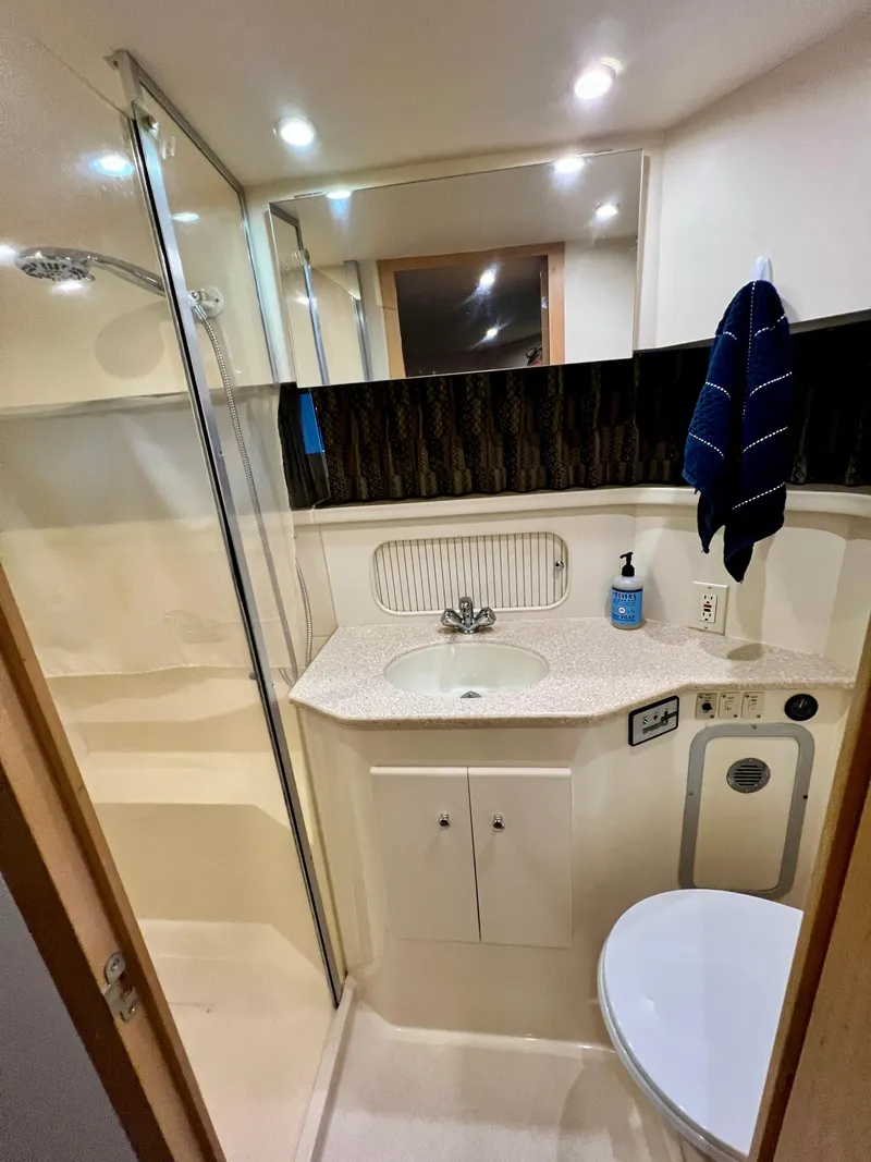 Slide: The Image of 1998 Carver 405 Aft Cabin bathroom with shower, sink, and toilet. - 17