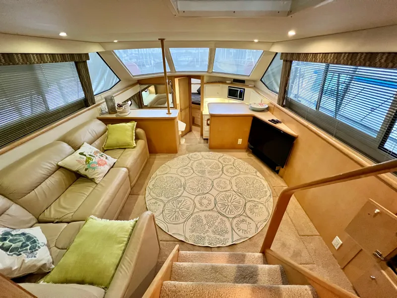 Slide: The Image of Luxurious interior of 1998 Carver 405 Aft Cabin yacht with cozy seating and modern amenities. - 2