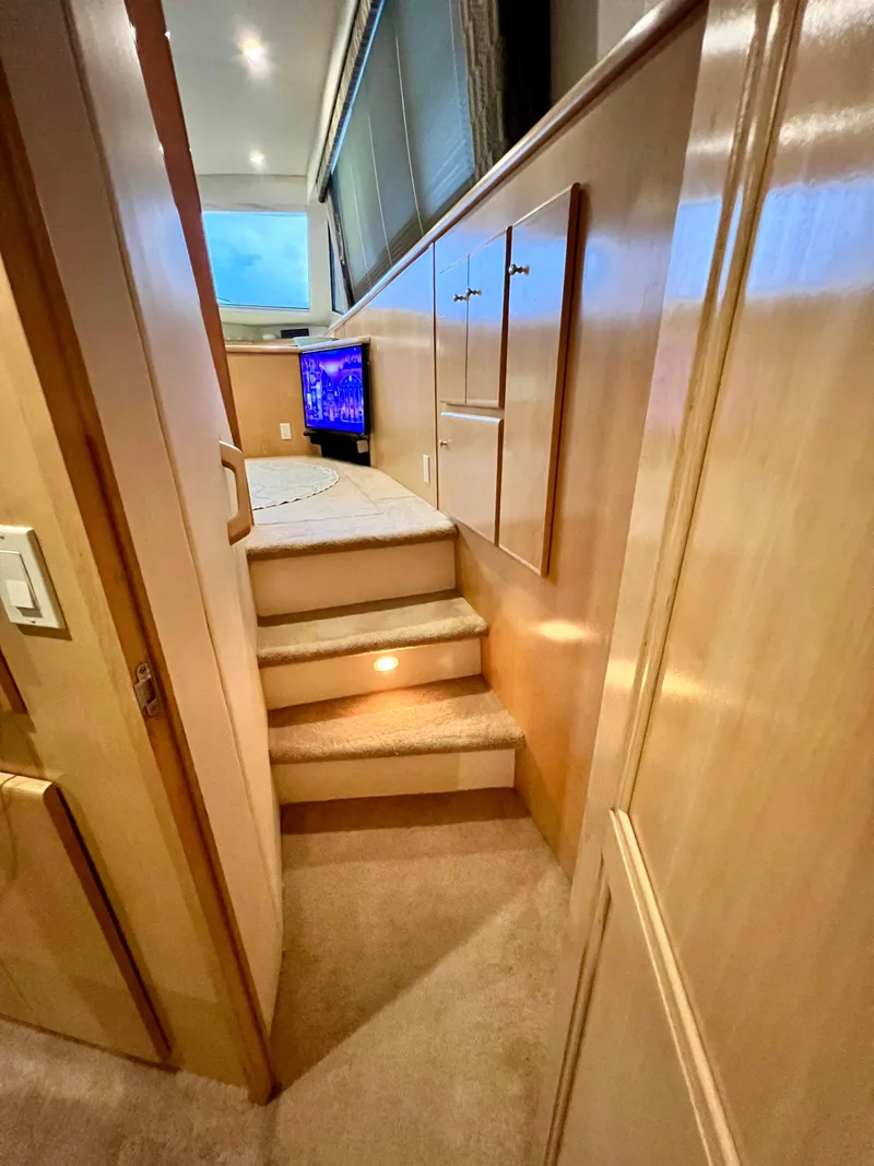 Slide: The Image of 1998 Carver 405 Aft Cabin interior with carpeted stairs and wooden cabinetry. - 20