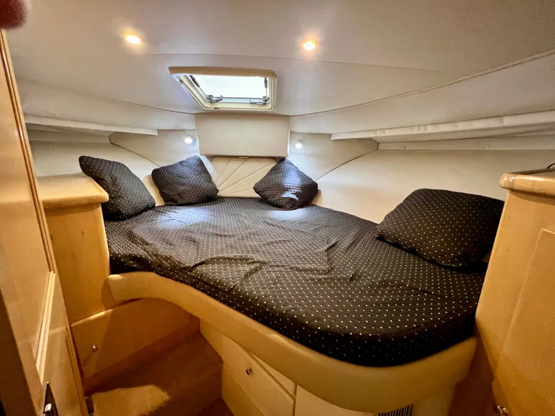 Slide: The Image of 1998 Carver 405 Aft Cabin bedroom with cozy bedding and ambient lighting. - 21