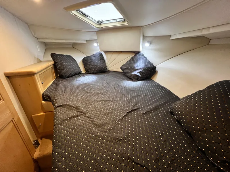Slide: The Image of 1998 Carver 405 Aft Cabin interior with cozy bed and overhead window. - 22