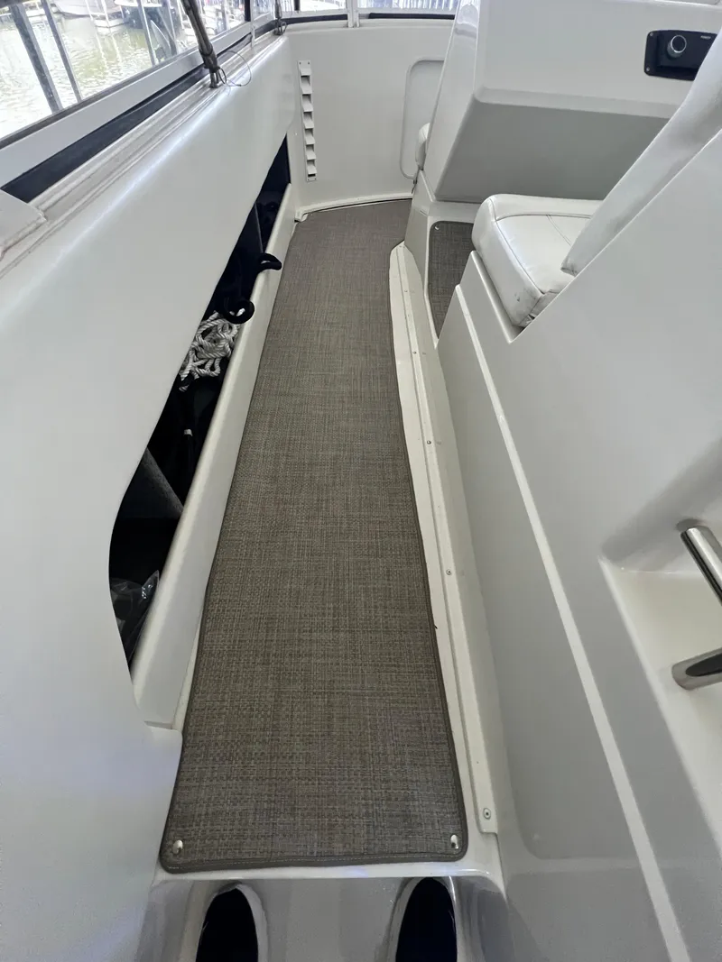 Slide: The Image of 1998 Carver 405 Aft Cabin interior with gray carpet and white seating. - 28