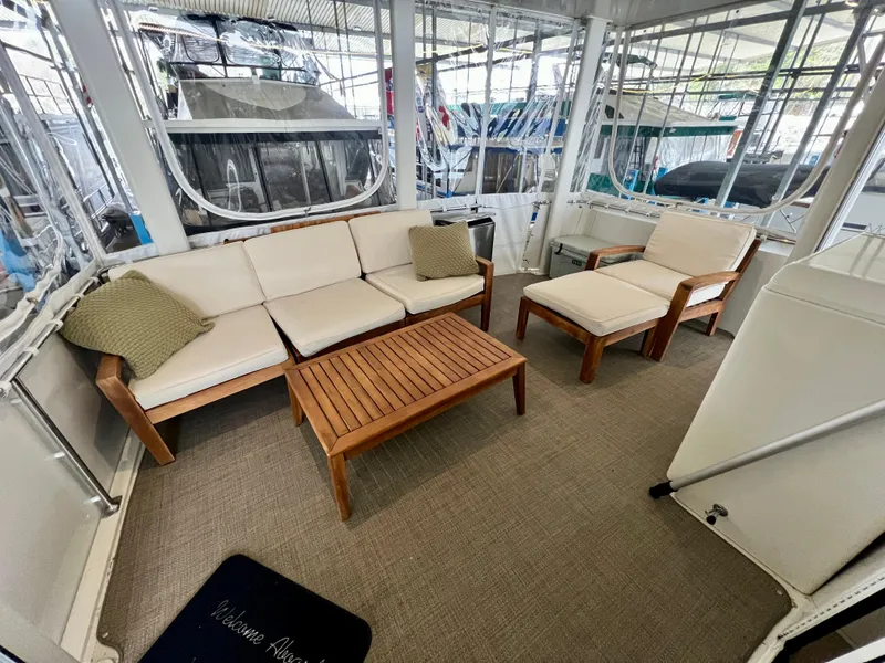 Slide: The Image of 1998 Carver 405 Aft Cabin interior with cozy seating and wooden table. - 34