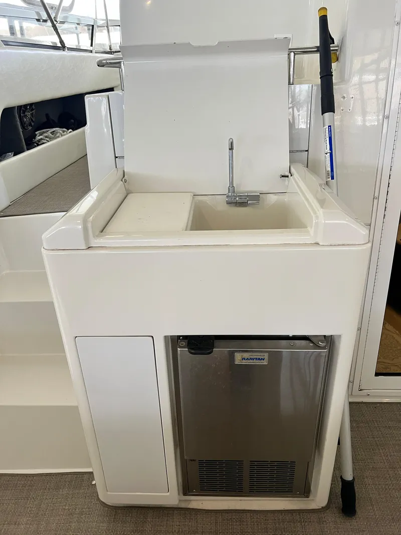 Slide: The Image of 1998 Carver 405 Aft Cabin yacht sink and mini fridge setup. - 37