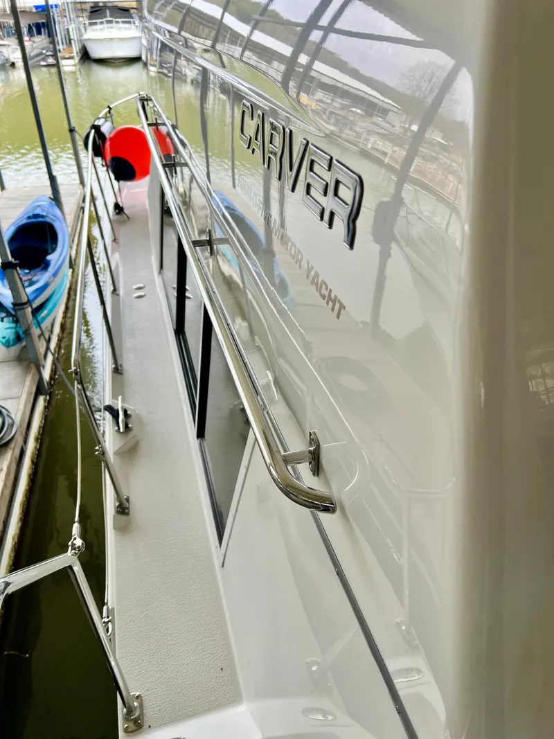 Slide: The Image of 1998 Carver 405 Aft Cabin yacht docked, showcasing sleek design and polished exterior. - 38