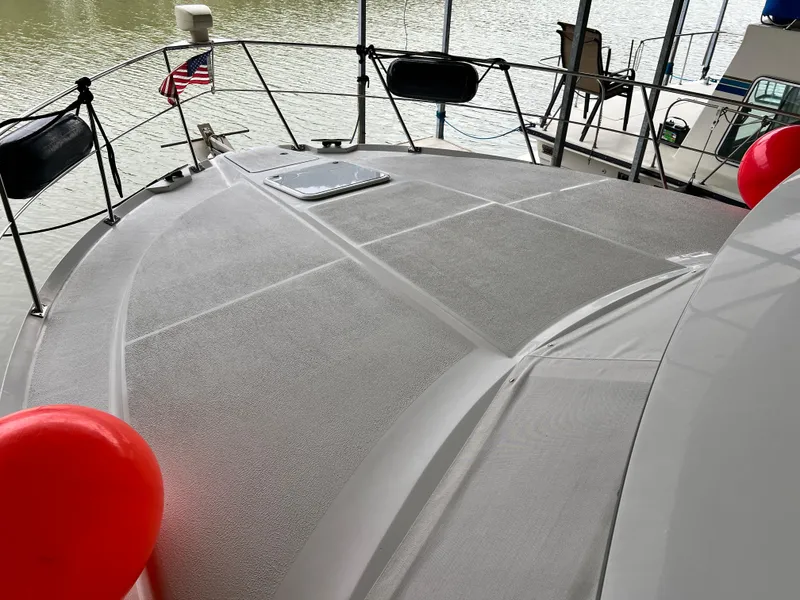 Slide: The Image of 1998 Carver 405 Aft Cabin boat deck with red balloons and American flag. - 39