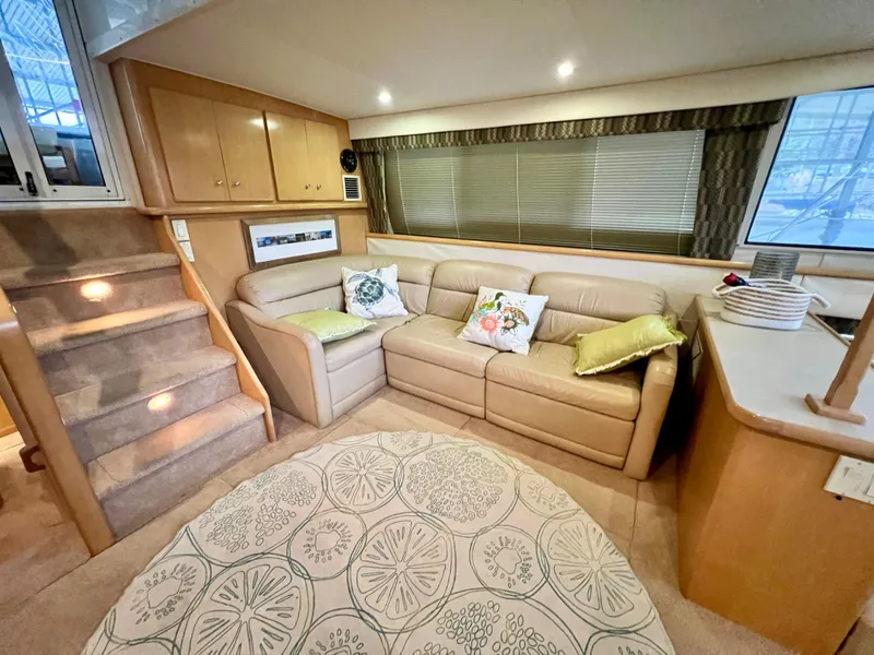 Slide: The Image of Luxurious interior of 1998 Carver 405 Aft Cabin with beige sofa and decorative pillows. - 4
