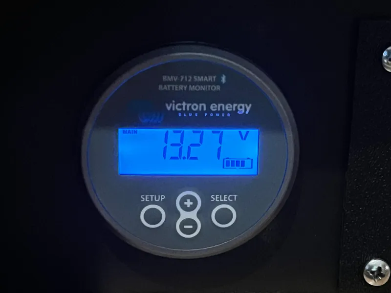Slide: The Image of Victron Energy BMV-712 battery monitor displaying 13.27 volts on Carver 405 Aft Cabin, 1998. - 43
