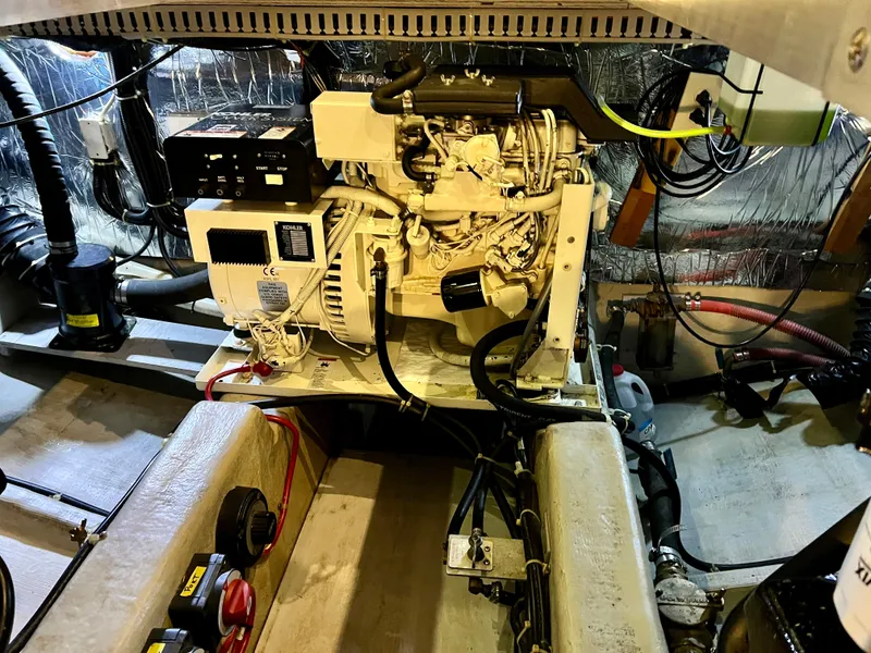 Slide: The Image of Engine room of 1998 Carver 405 Aft Cabin with visible generator and wiring. - 44