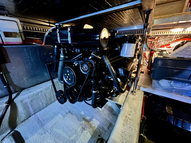 Slide: The Image of Engine compartment of a 1998 Carver 405 Aft Cabin boat, showcasing mechanical components. - 46