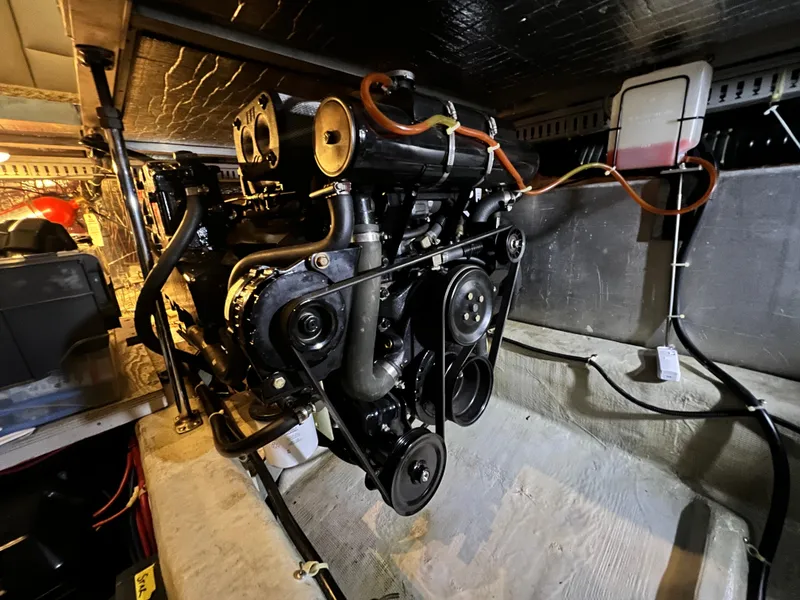 Slide: The Image of Engine compartment of a 1998 Carver 405 Aft Cabin boat, showcasing mechanical components. - 47