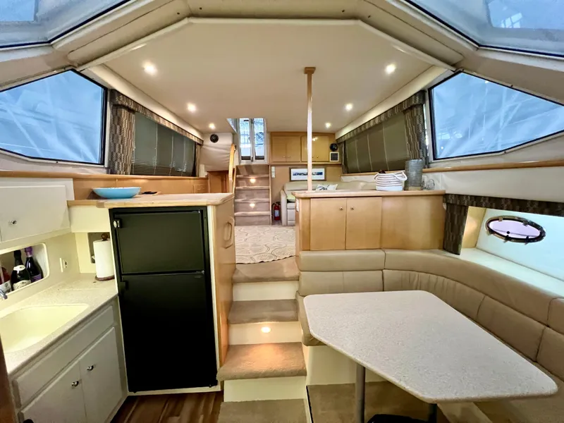 Slide: The Image of Interior of 1998 Carver 405 Aft Cabin yacht with modern kitchen and seating area. - 8
