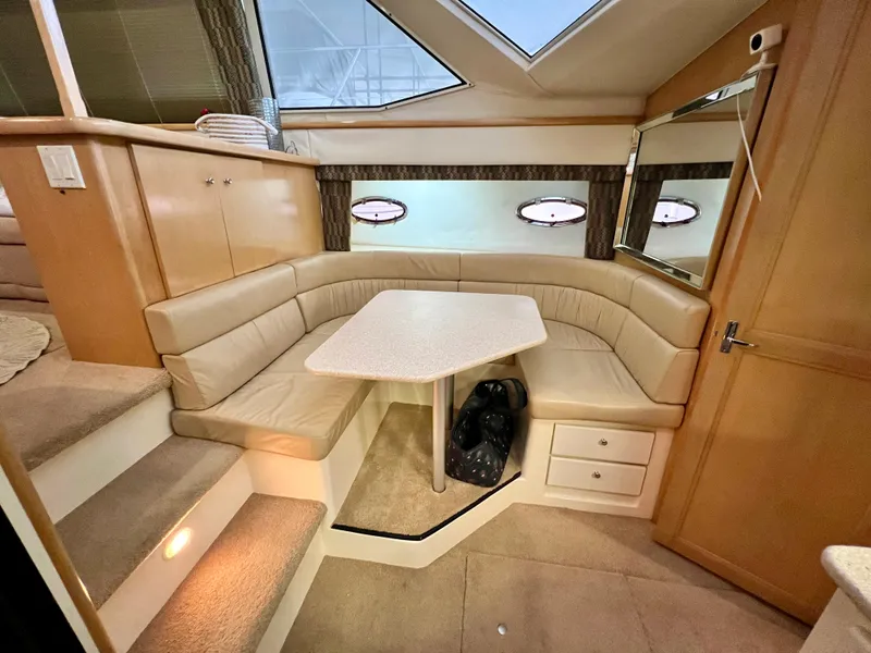 Slide: The Image of Interior of 1998 Carver 405 Aft Cabin with cozy seating and table. - 9