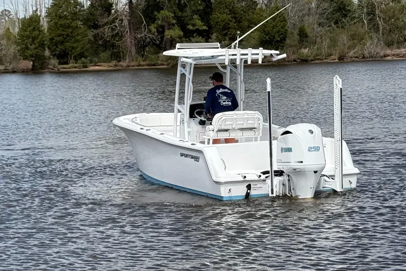 Slide: The Image of 2021 Sportsman Heritage 231 Center Console boat on a calm lake. - 11