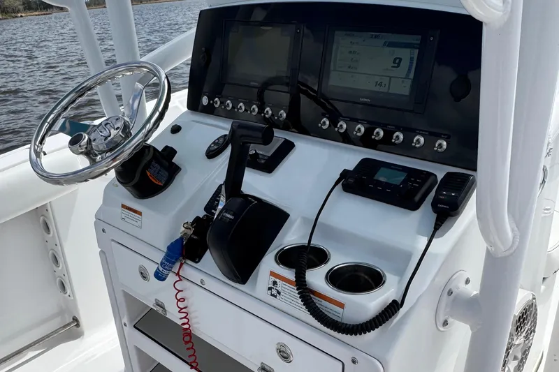 Slide: The Image of 2021 Sportsman Heritage 231 Center Console dashboard with steering wheel and electronic controls. - 21