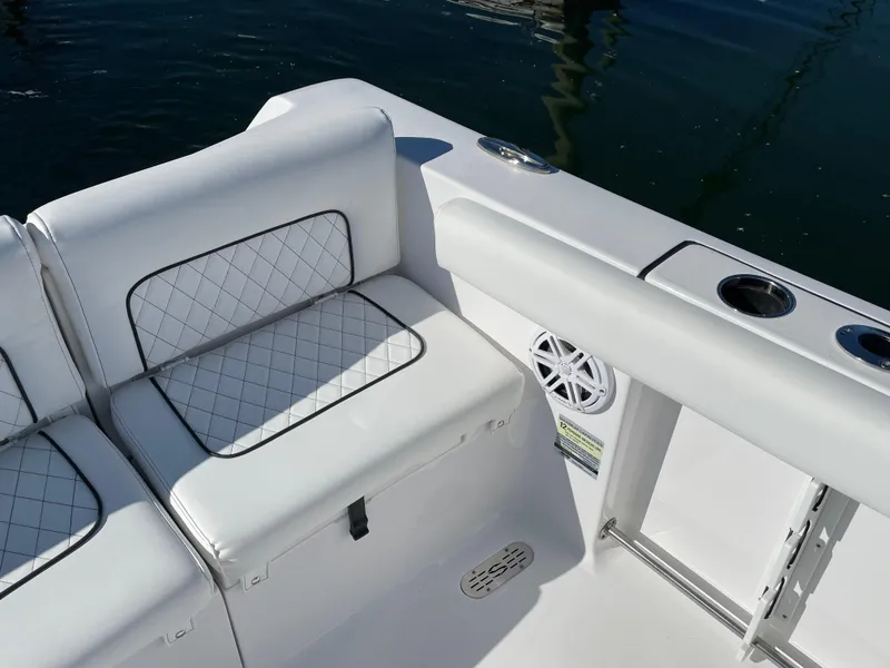 Slide: The Image of 2021 Sportsman Heritage 231 Center Console boat interior with white cushioned seating. - 25