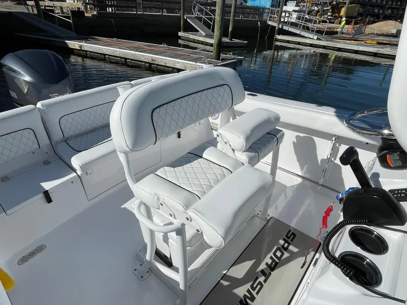 Slide: The Image of 2021 Sportsman Heritage 231 Center Console boat interior with white cushioned seating. - 27