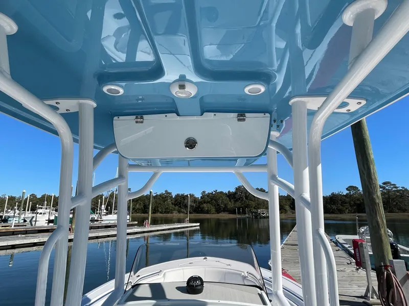 Slide: The Image of 2021 Sportsman Heritage 231 Center Console boat with blue T-top at marina. - 29