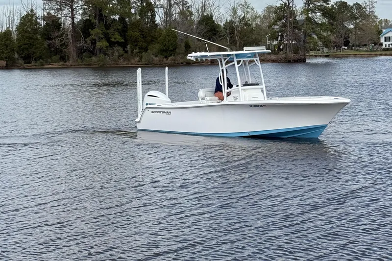 Slide: The Image of 2021 Sportsman Heritage 231 Center Console boat cruising on a calm lake. - 3