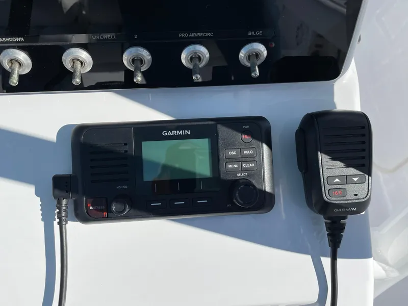 Slide: The Image of Garmin marine radio and controls on 2021 Sportsman Heritage 231 Center Console boat. - 34