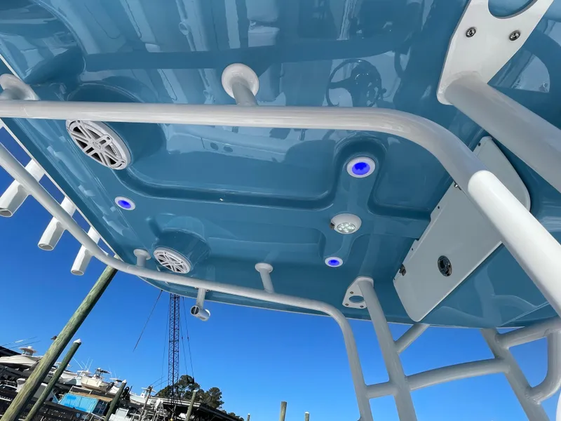 Slide: The Image of 2021 Sportsman Heritage 231 Center Console boat with blue LED lights and speakers. - 36