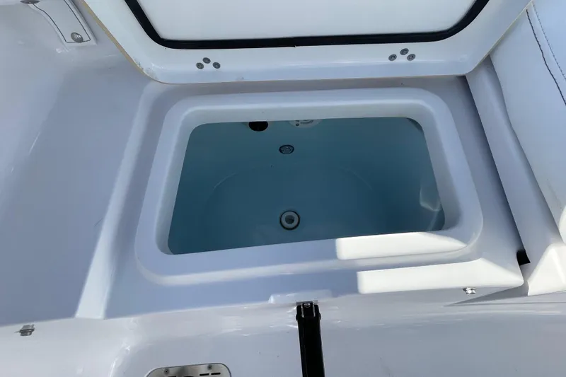 Slide: The Image of Open storage compartment on 2021 Sportsman Heritage 231 Center Console boat. - 46