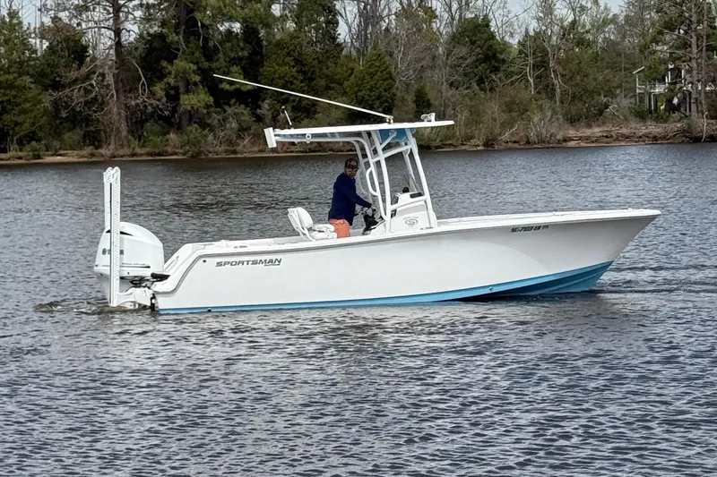 Slide: The Image of 2021 Sportsman Heritage 231 Center Console boat on a calm lake. - 5