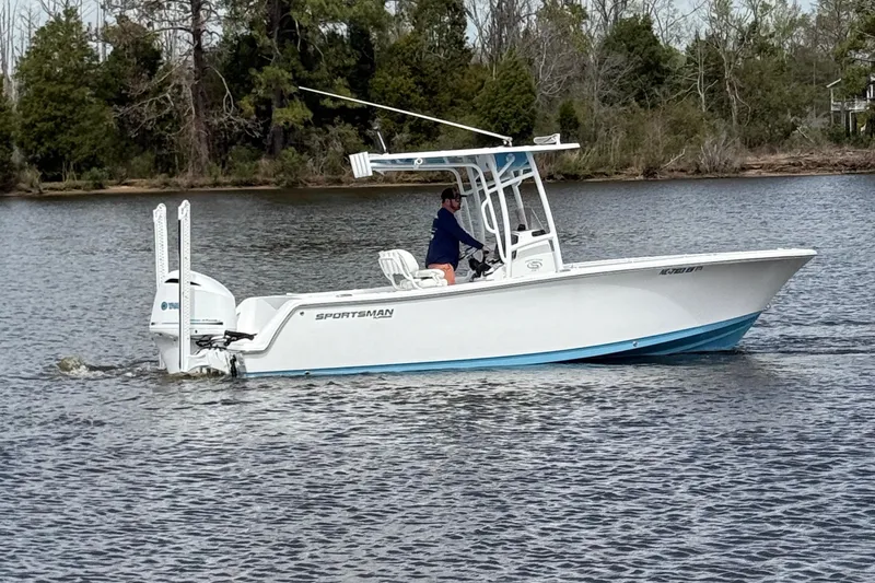 Slide: The Image of 2021 Sportsman Heritage 231 Center Console boat cruising on a calm lake. - 6