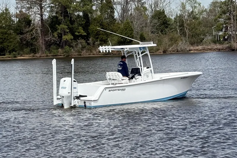 Slide: The Image of 2021 Sportsman Heritage 231 Center Console boat cruising on a calm lake. - 7