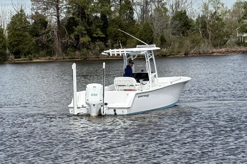Slide: The Image of 2021 Sportsman Heritage 231 Center Console boat cruising on a calm lake. - 9