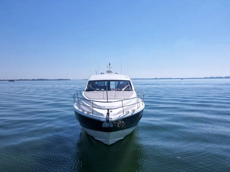 Slide: The Image of 2013 Fairline Targa 50 GT yacht on calm water under clear blue sky. - 3